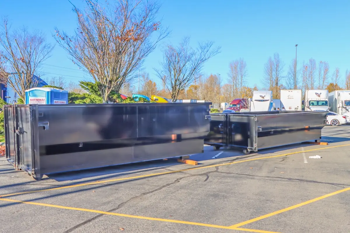 Professional dumpster rental service with roll-off container on residential driveway in Tehaleh